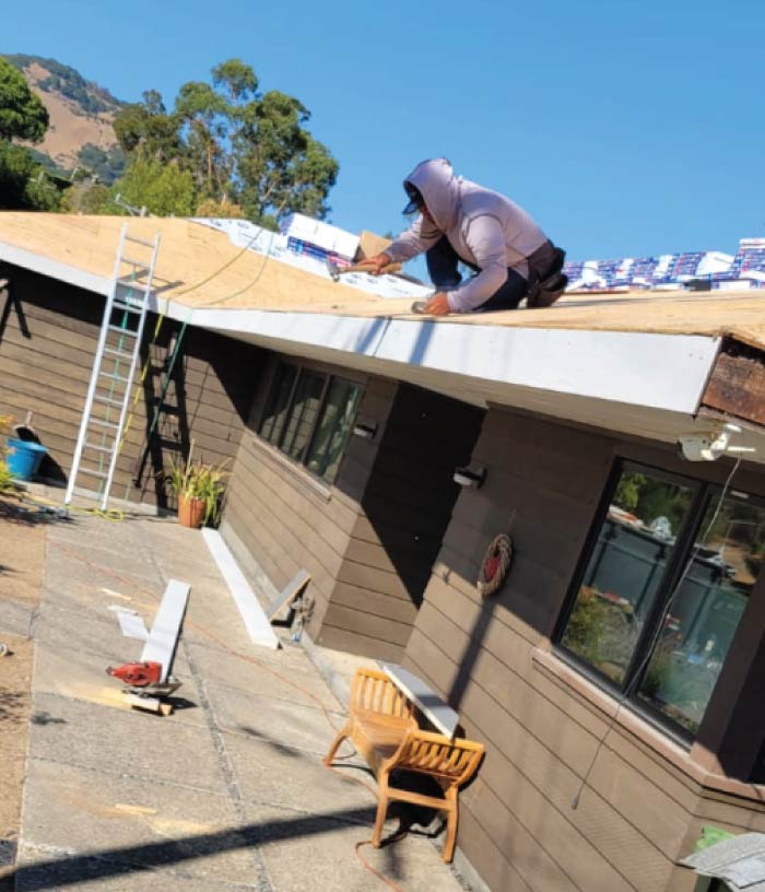 roofer in woodland, ca installing a gutter system