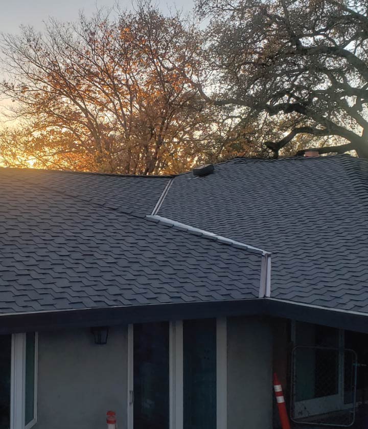 asphalt shingle roof with a gutter system installed